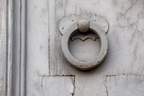 Door knocker on an old wooden door, Rome, Italy, Europe
