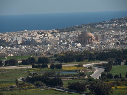 Panoramic view of a town near the sea with a striking dome and mediterranean buildings, the town of