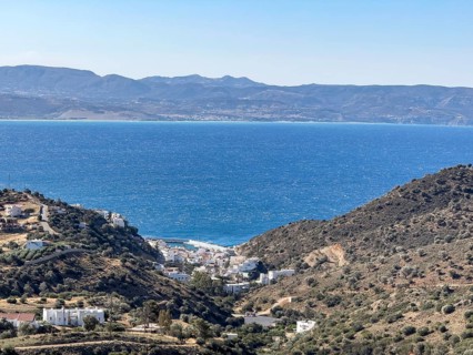 View of in the foreground former fishing village with sheltered safe harbour on the south coast of