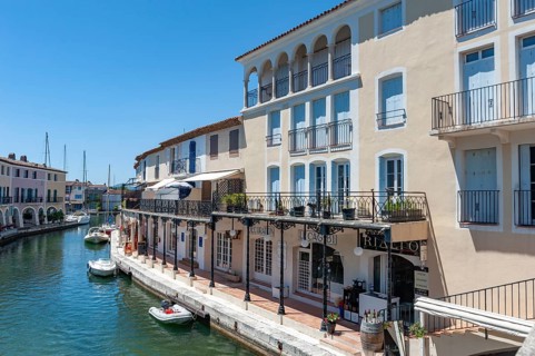 Townscape with restaurants and shops at the Pont principal du port grimaud, Port Grimaud, Var,