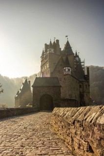 View of Eltz Castle. A landscape in autumn on a frosty morning with ripe and fog. The famous castle