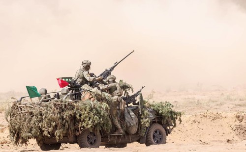 Dutch soldiers on a camouflaged Serval during the NATO Steadfast Defender large-scale manoeuvre in