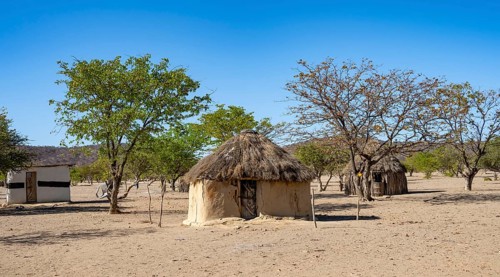 Mud huts in a village of the Hakaona, Angolan tribe of the Hakaona, near Opuwo, Kunene, Namibia,