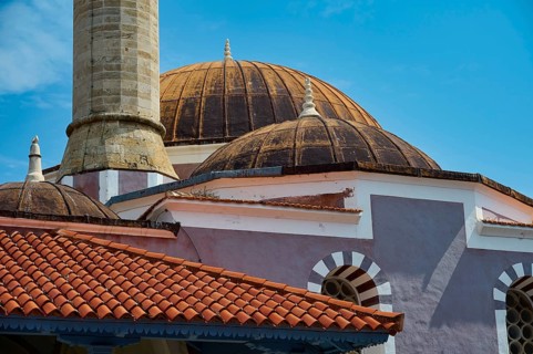 Suleiman Mosque, detailed view of historic domed building and minaret with red roofs under blue