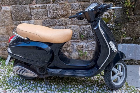 Black Vespa in front of an old stone wall, Rhodes, Greece, Europe