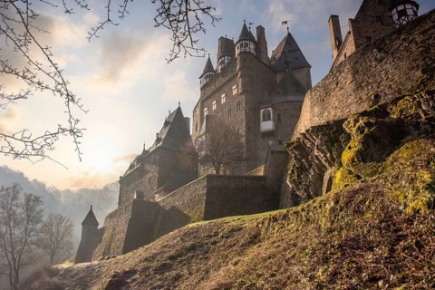 View of Eltz Castle. A landscape in autumn on a frosty morning with ripe and fog. The famous castle
