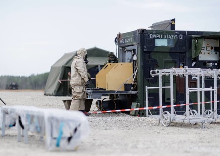 German soldiers from an NBC defence unit in protective clothing practise decontamination during the
