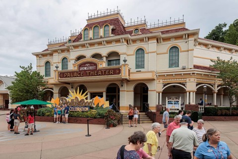 Groups of guests get photos taken in front of the Showstreet Palace Theater at the Dollywood