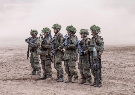 The crew of a Cougar infantry fighting vehicle presents itself at the NATO large-scale manoeuvre