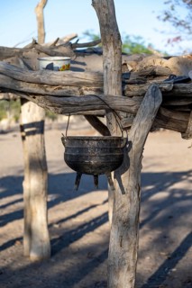 Kettle, cooking pot hanging on a wooden rack, Hakaone village, near Opuwo, Kunene, Namibia, Africa
