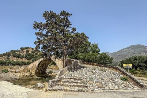 View of stairway with coarse cobblestones of historic classical arched stone bridge in Venetian