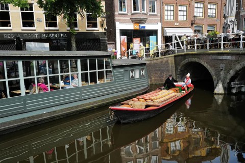 A load of Beemster cheese being transported on a canal in the city centre on market day., Alkmaar,