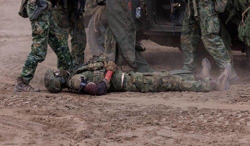 Dutch soldiers care for a simulated injured comrade as part of the NATO large-scale manoeuvre