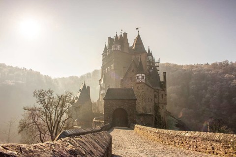 View of Eltz Castle. A landscape in autumn on a frosty morning with ripe and fog. The famous castle