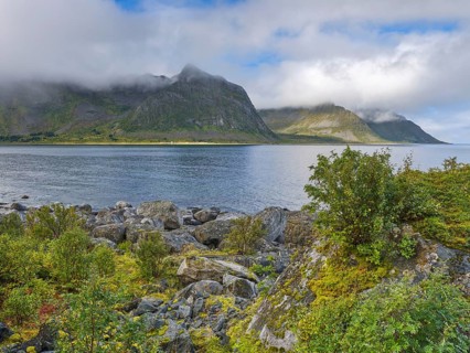 Rocky coast of Tungeneset, fog and blue sky, Senja, Norway, Europe