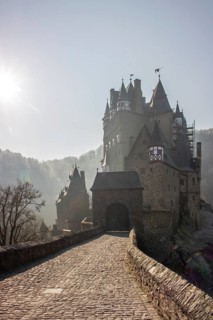 View of Eltz Castle. A landscape in autumn on a frosty morning with ripe and fog. The famous castle
