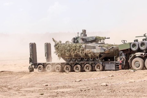 A Cougar infantry fighting vehicle is unloaded from a Mammut heavy goods transporter during the