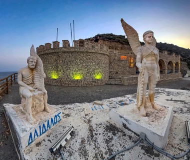 Photo at dusk evening mood of illuminated monument to Daedalus and Icarus on cliff of flight for