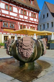 Fountain with inscription Gemmingen, stone grapes, water features, Ratsstueble restaurant at the