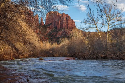 Cathedral Rock sandstone formations tower over Oak Creek at the Crescent Moon Picnic Site in