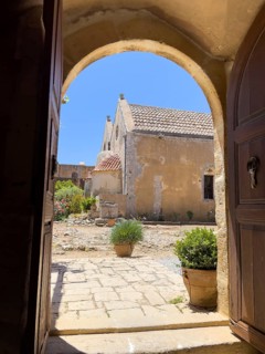 View through door Tor tor archway archway on back of two-aisled church building church monastery