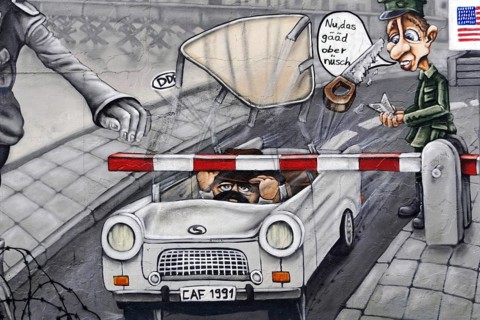Detailed mural shows a caricature of soldiers at a checkpoint, car with humorous elements, mural,