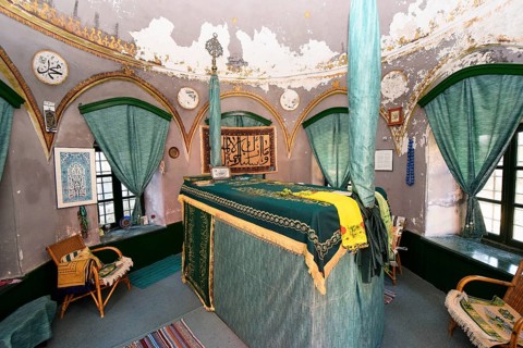 Mausoleum, prayer room with cloth-covered tomb, religious symbols and furnished with chairs and