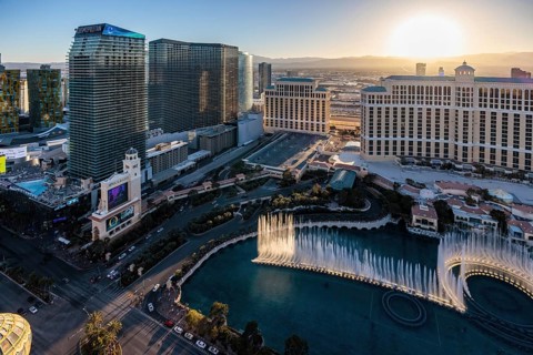 Sun setting behind the Bellagio Casino during a fountain show on the strip in Las Vegas, Nevada,
