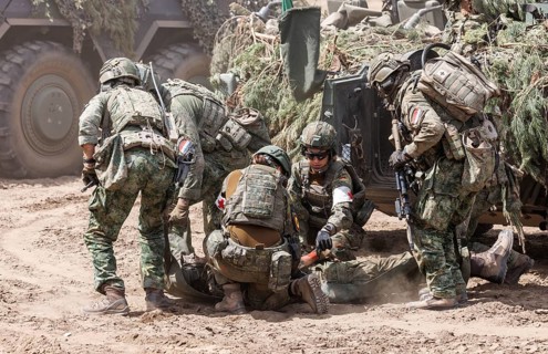 German and Dutch soldiers care for a simulated injured comrade as part of the NATO large-scale