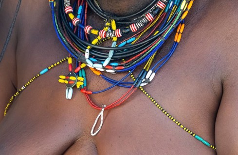 Detail, traditional necklace of a Hakaona woman, pearl necklaces with pendants, in the morning