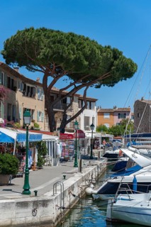 Townscape near Rue de l'Octogne with shops selling souvenirs and bric-a-brac, Port Grimaud, Var,