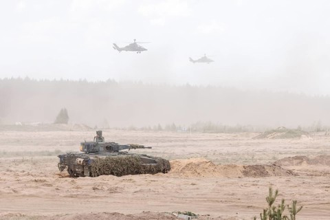 A Cougar infantry fighting vehicle and two Tiger combat helicopters, photographed during the NATO