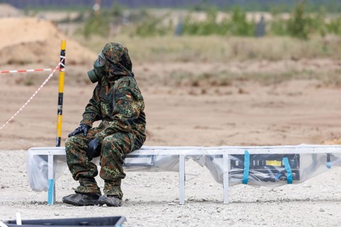 German soldiers from an NBC defence unit in protective clothing practise decontamination during the