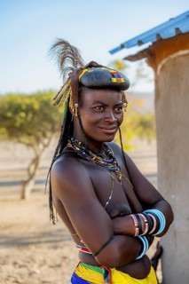 Hakaona woman with traditional kapapo hairstyle and hair ornaments with ostrich feathers and