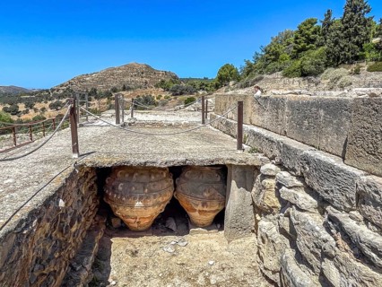 View into historical storeroom below present floor level with two large decorated clay vessels