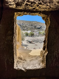 View from cave dwelling of former Roman necropolis later living cave for hippies dropouts on beach