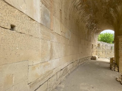 Wall of archway behind amphitheatre carved written chiselled laws City law of Gortys carved in