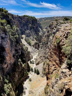 View to the south-west from bridge over deep narrow Aradena gorge to steep rugged rocks, at the