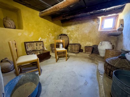 Historic small living room cell of monk Monk's cell with baskets and chairs in UNESCO World