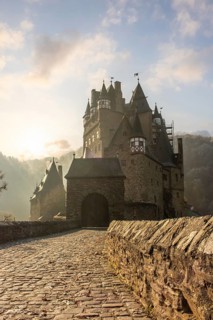 View of Eltz Castle. A landscape in autumn on a frosty morning with ripe and fog. The famous castle