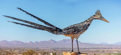 Panorama of Giant Recycled Roadrunner statue made entirely from discarded materials by artist Olin