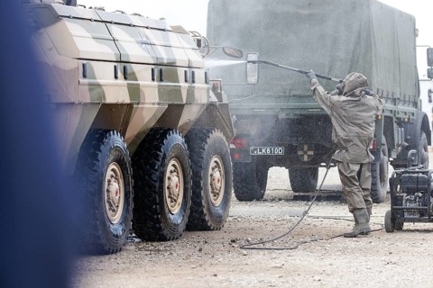 German soldiers of an NBC defence unit in protective clothing practice decontamination of an