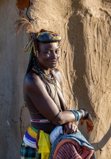 Hakaona woman with traditional kapapo hairstyle and hair ornaments with ostrich feathers and