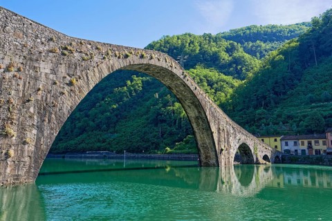 The historic Ponte della Maddalena bridge over the River Serchio in Garfagnana, Borgo a Mozzano,