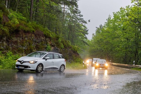 Car traffic during a thunderstorm in the Saxon Switzerland, cloudburst, Hohnstein, Saxony, Germany,