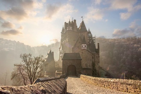 View of Eltz Castle. A landscape in autumn on a frosty morning with ripe and fog. The famous castle