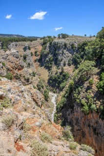 View to the north-east of the steep rock face of Aradena Gorge in the centre below Hiking trail