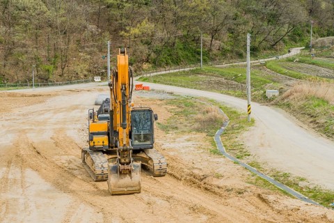 Front view of backhoe parked at rural construction site in Daejeon, South Korea, Asia