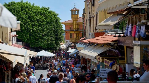 Mehmet Aga Mosque, Lively market square with many people and numerous shops under summer weather