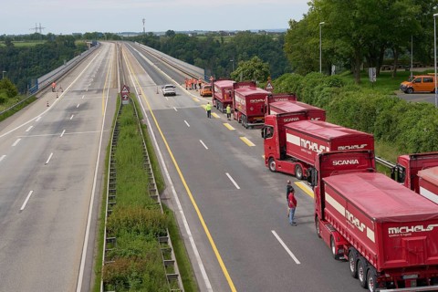 Trucks with a total weight of 960 tonnes stand on the Moselle valley bridge in Winningen during a